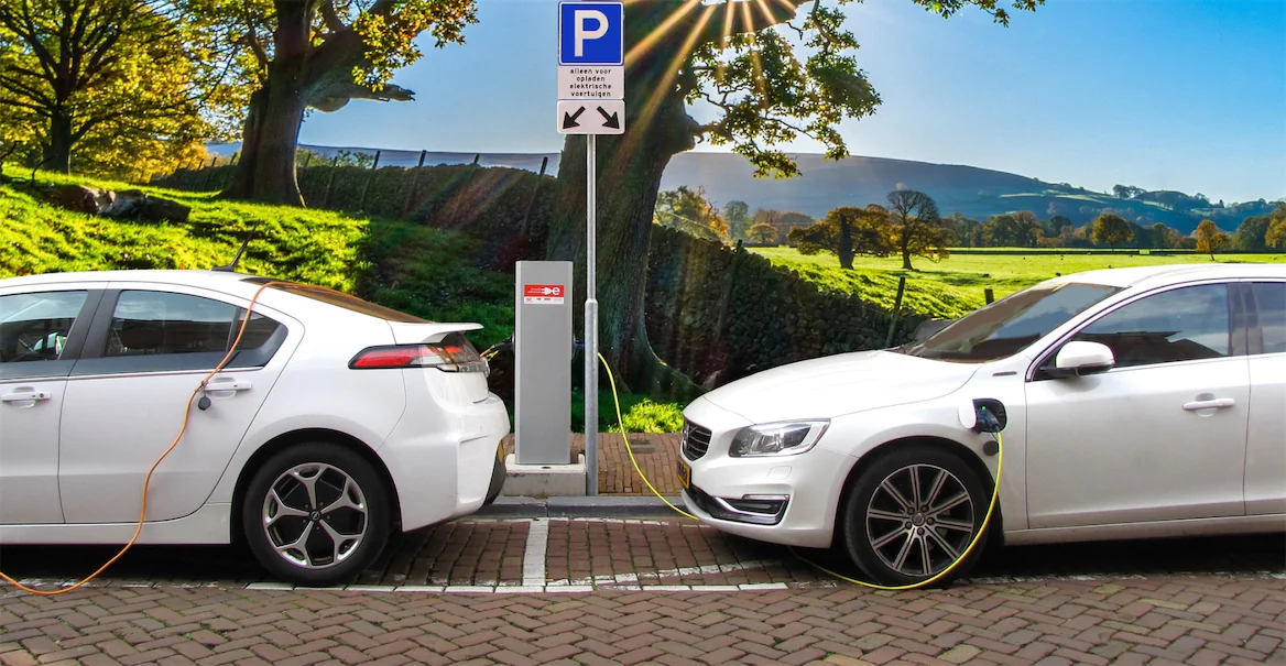 Electric vehicles charging at public charging station, illustrating California's EV infrastructure for Lemon Law coverage