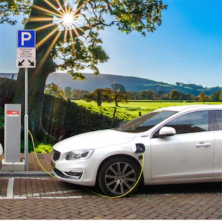 Electric vehicles charging at public charging station, illustrating California's EV infrastructure for Lemon Law coverage
